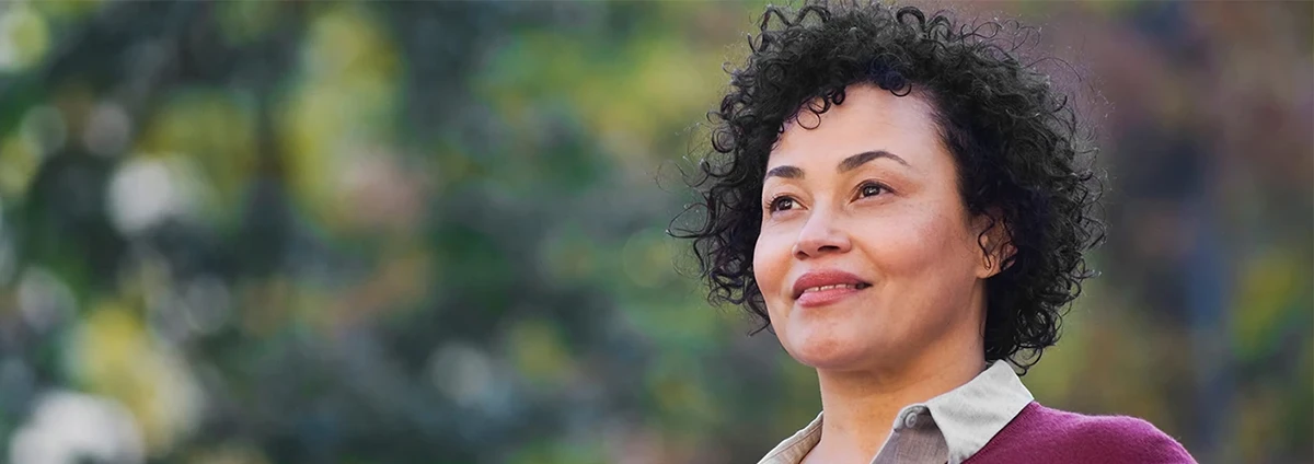 Smiling woman confidently looks into the distance 