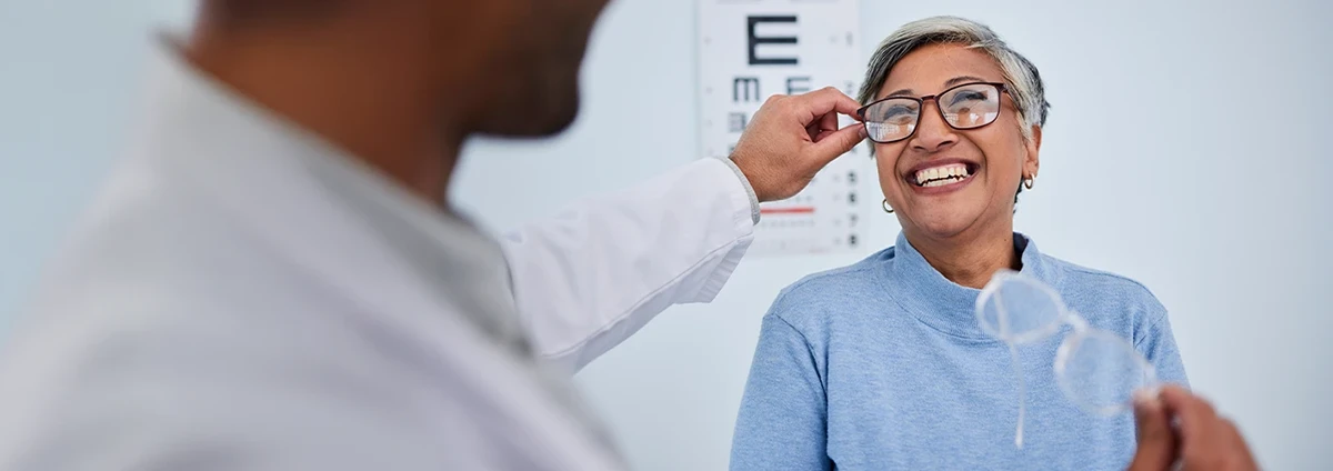 A woman tries on a pair of glasses
